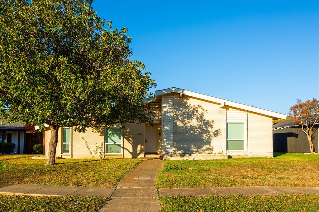 a view of a house with a tree in front