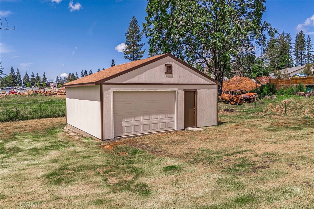 a view of a house with a yard and garage