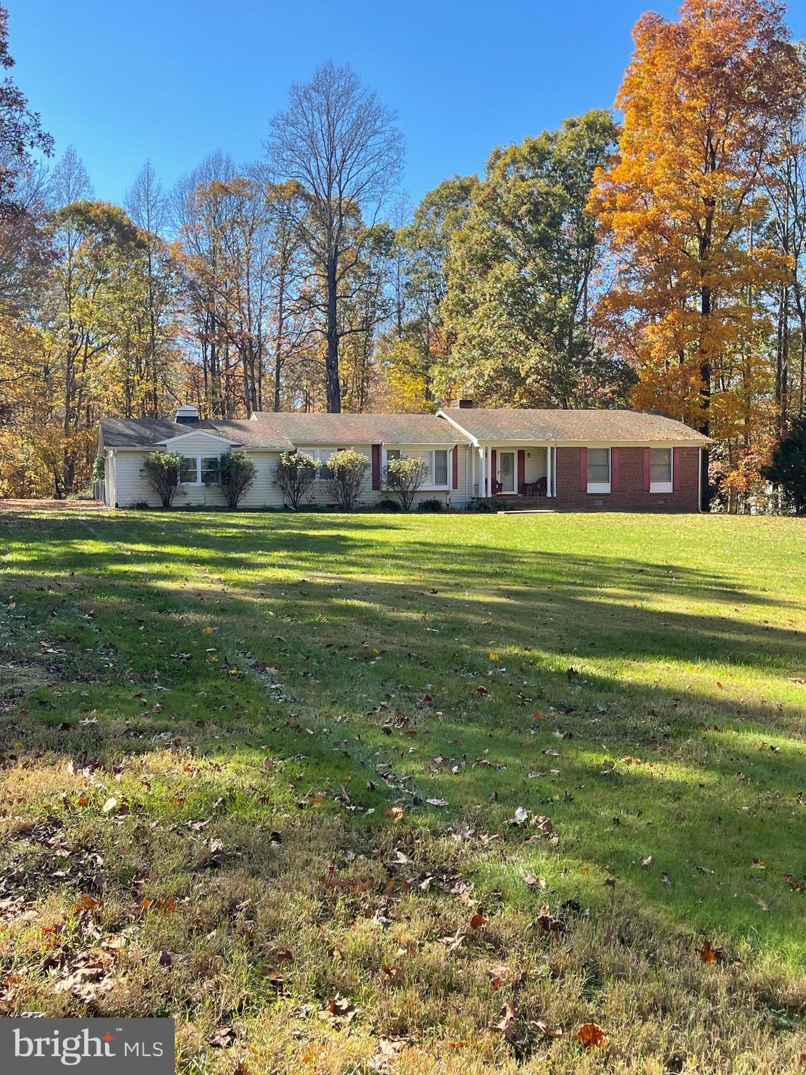 a front view of a house with a yard and trees