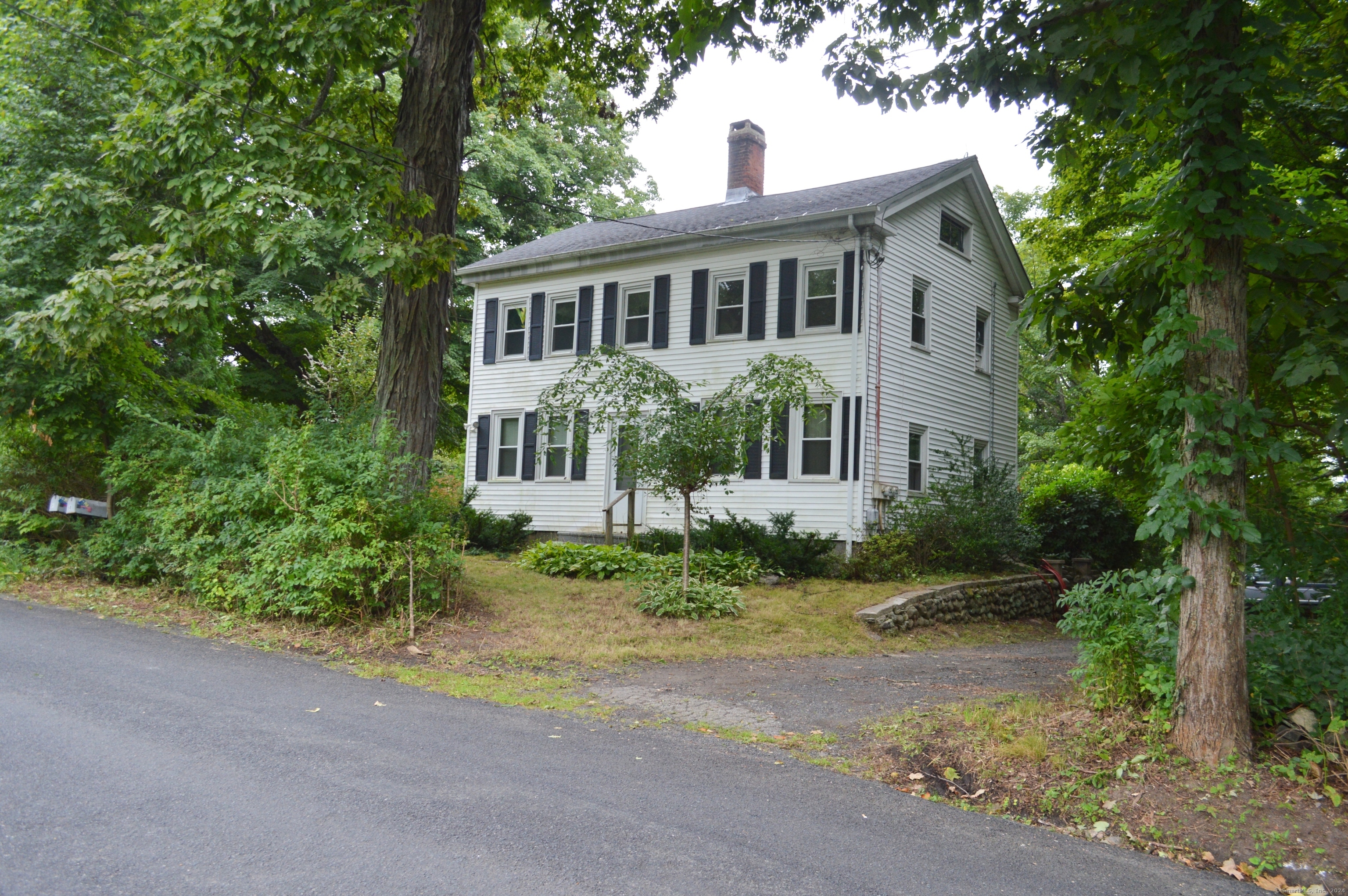 a front view of a house with a garden and porch