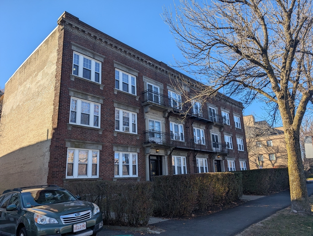 a front view of a building with a yard