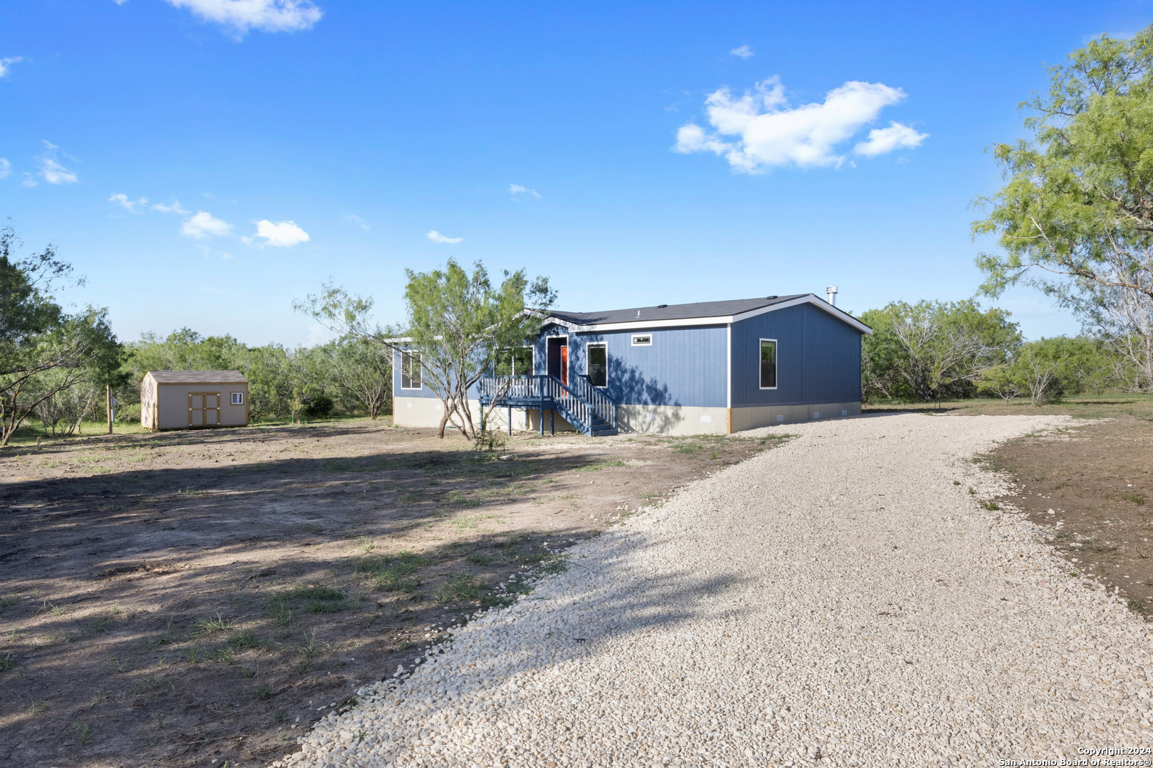 a house with a yard and a large parking space