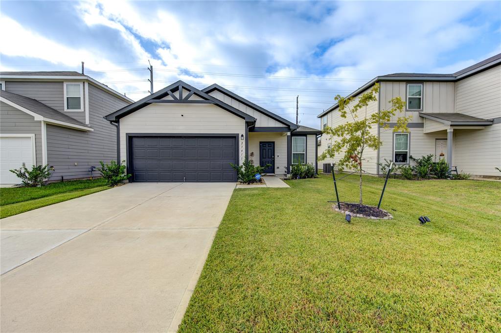 a view of a house with a yard and pathway