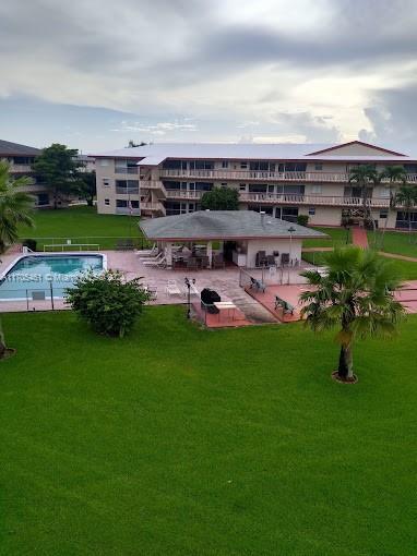 a view of a big yard with table and chairs