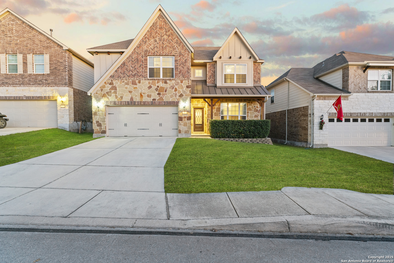 a front view of a house with a yard and garage