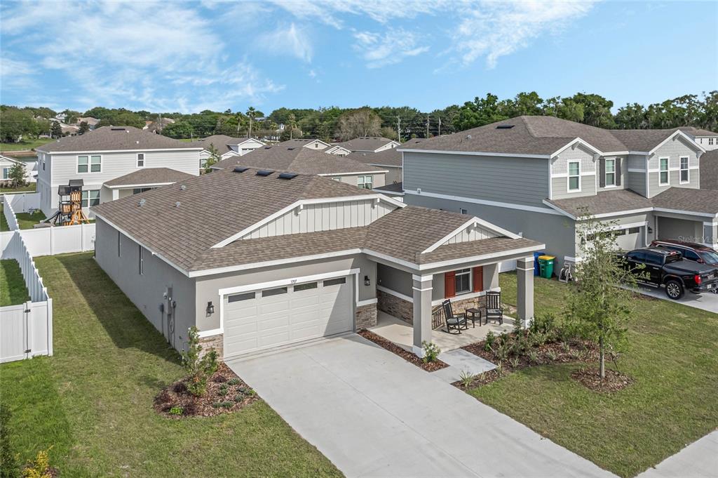 an aerial view of a house with a yard