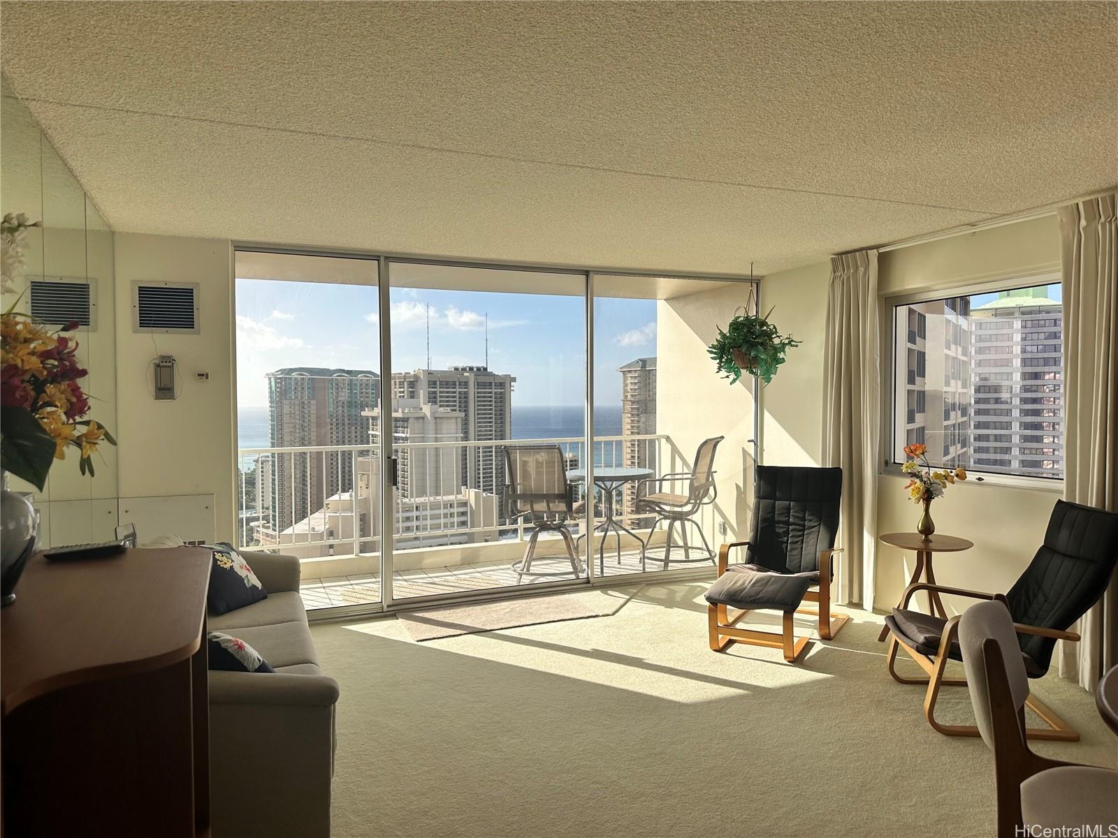 a living room with furniture and a floor to ceiling window