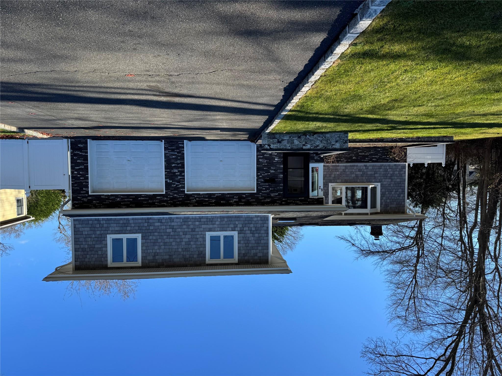 a view of a house with swimming pool in front of it