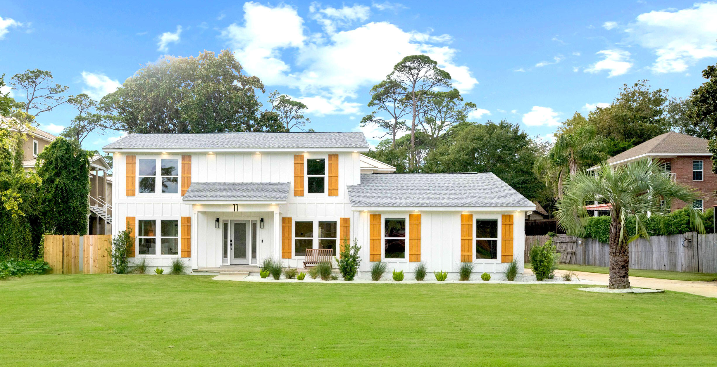 a front view of a house with a garden