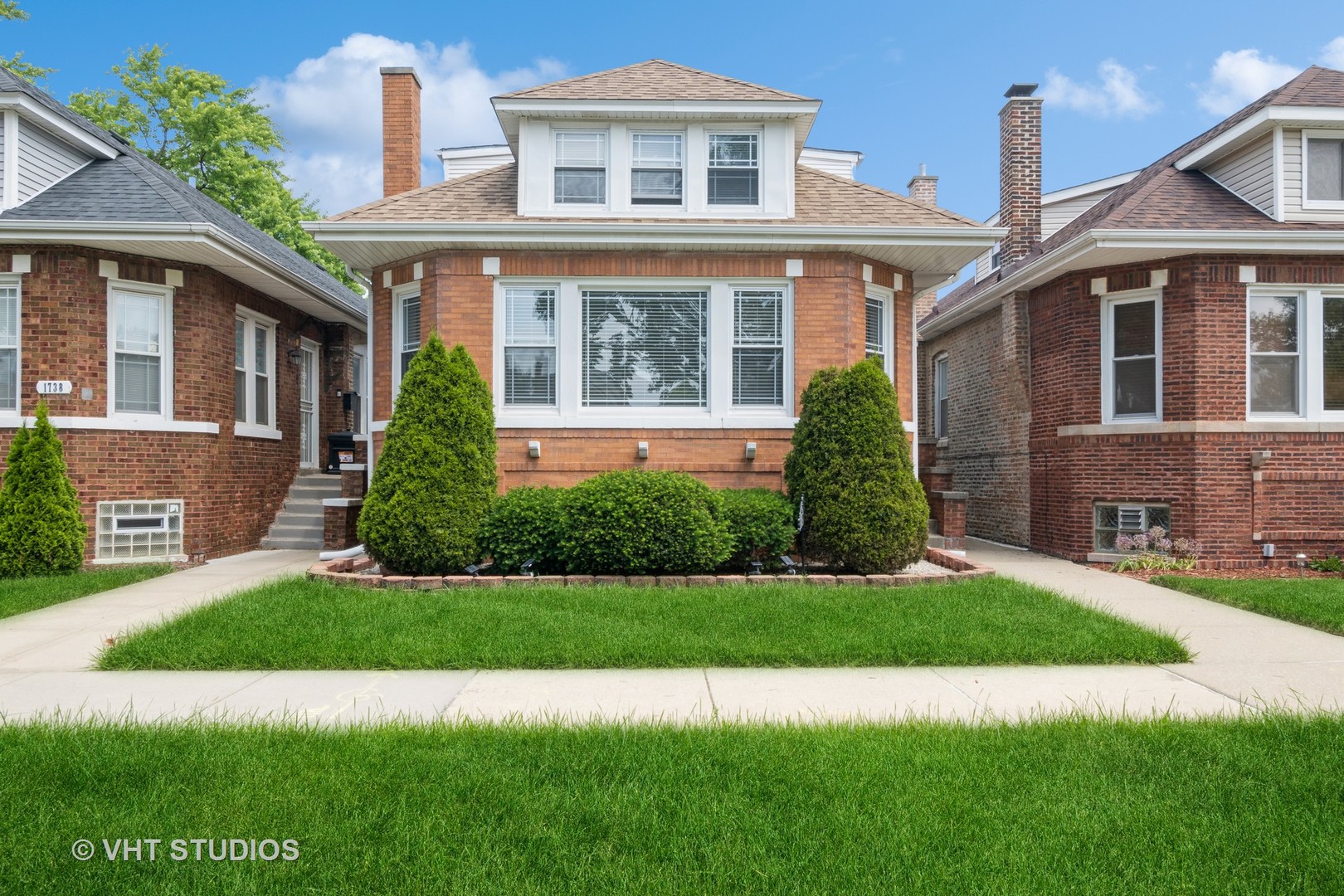 a front view of a house with a yard