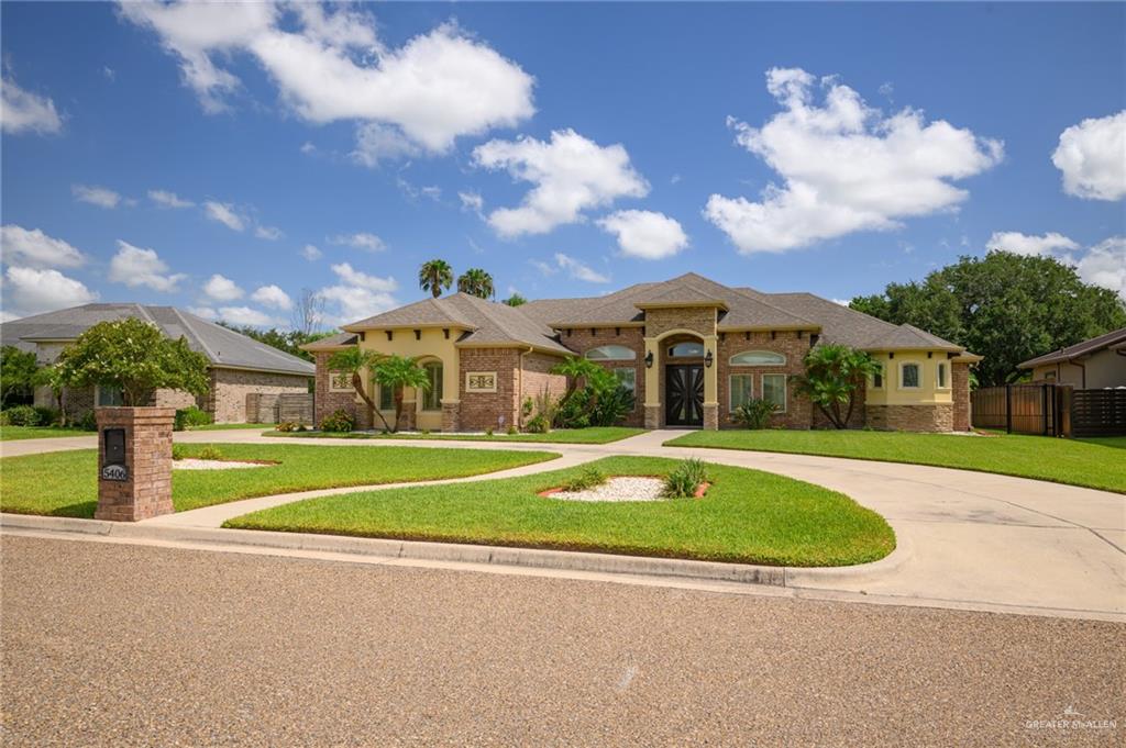 a view of a house with a swimming pool and a yard