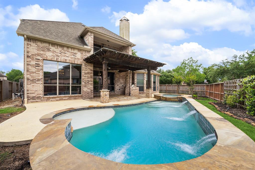 a view of a house with swimming pool and sitting area