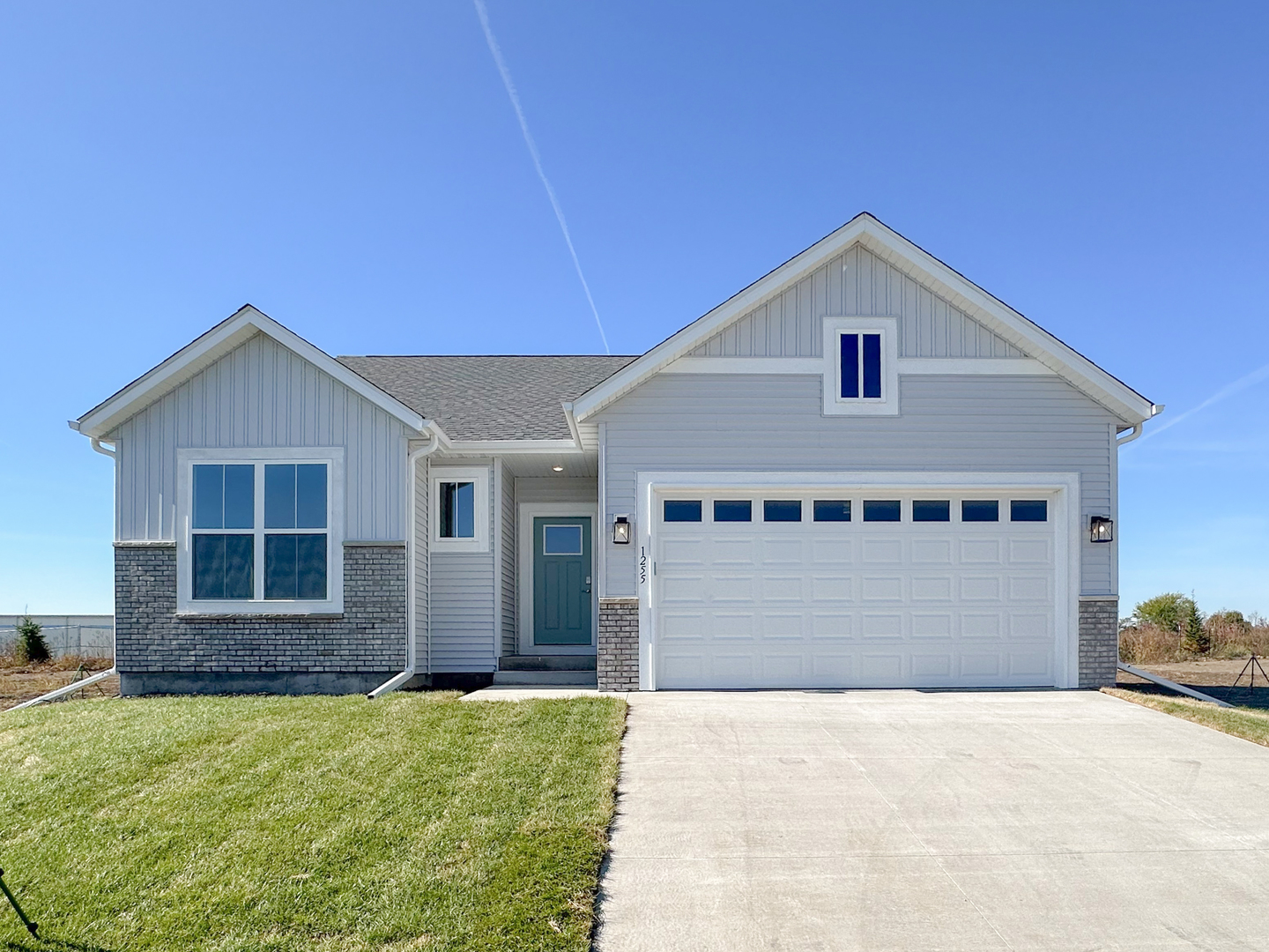 a view of a house with a yard and garage