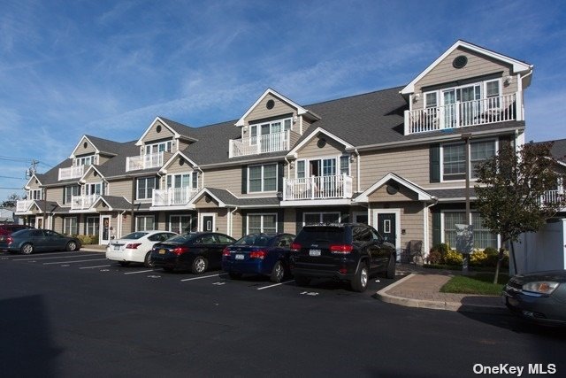 a front view of a residential apartment building with parking space and parking space