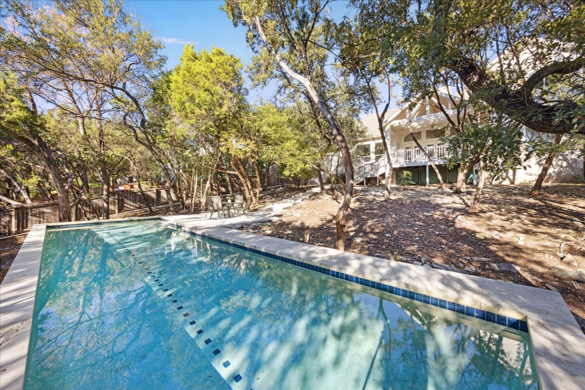 a view of backyard with wooden fence