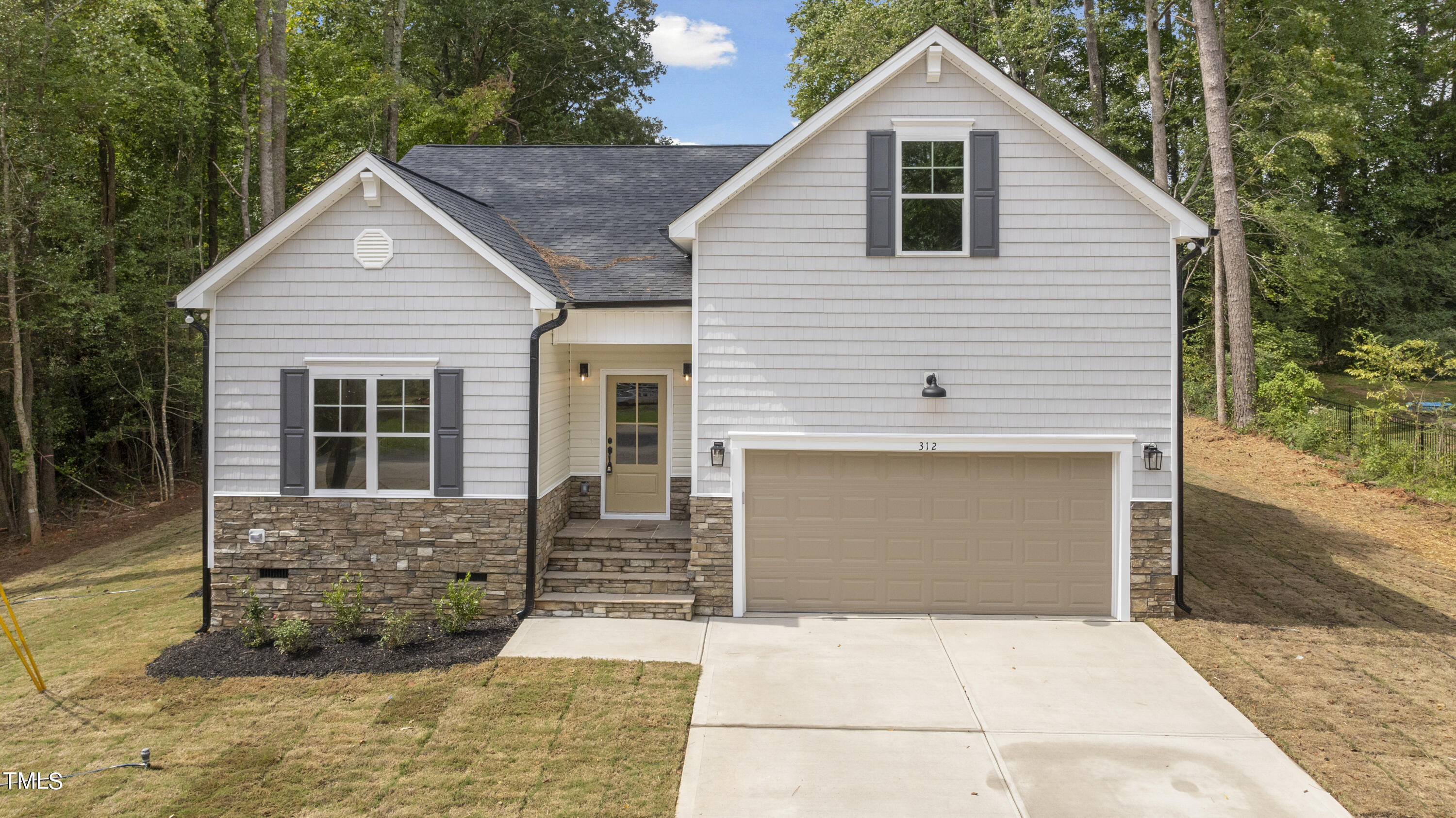 a front view of a house with garage