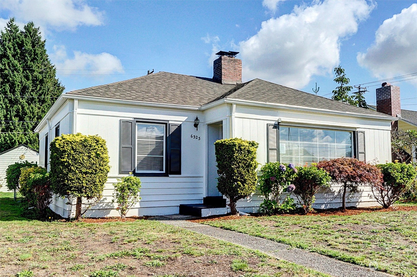 a front view of a house with garden