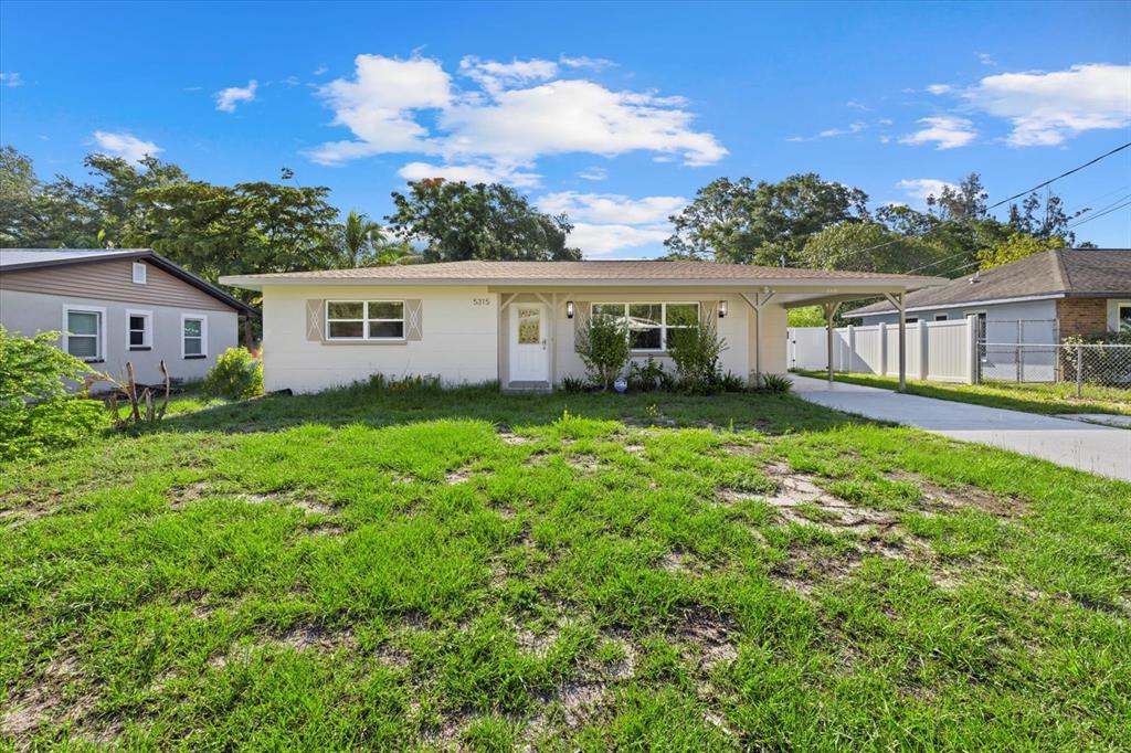 a view of a house with yard and a garden