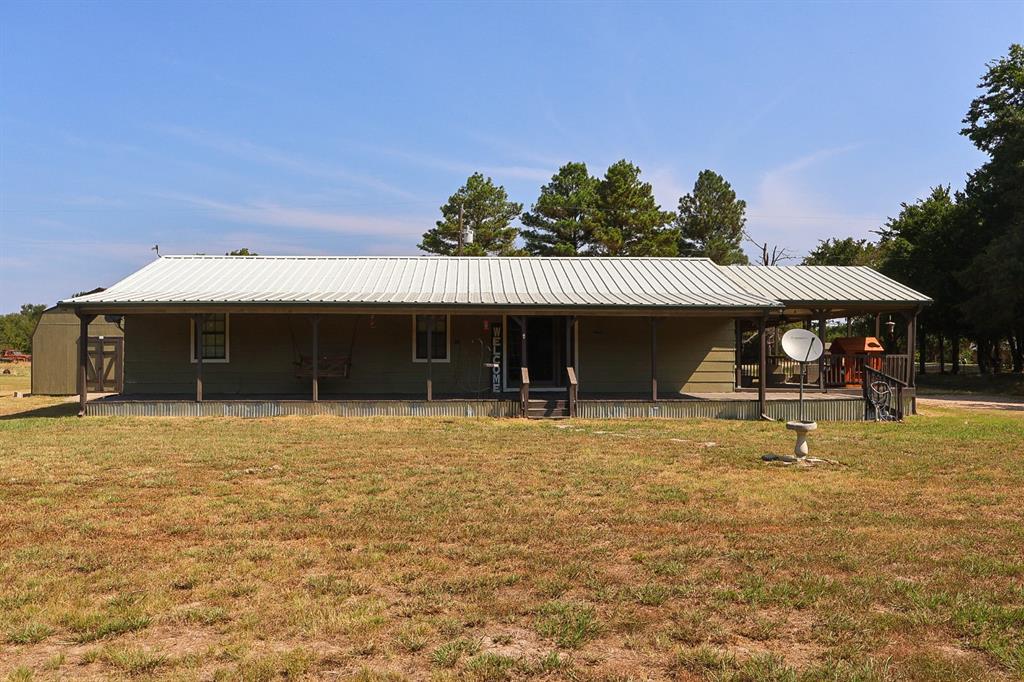 a view of a house with a yard and sitting area