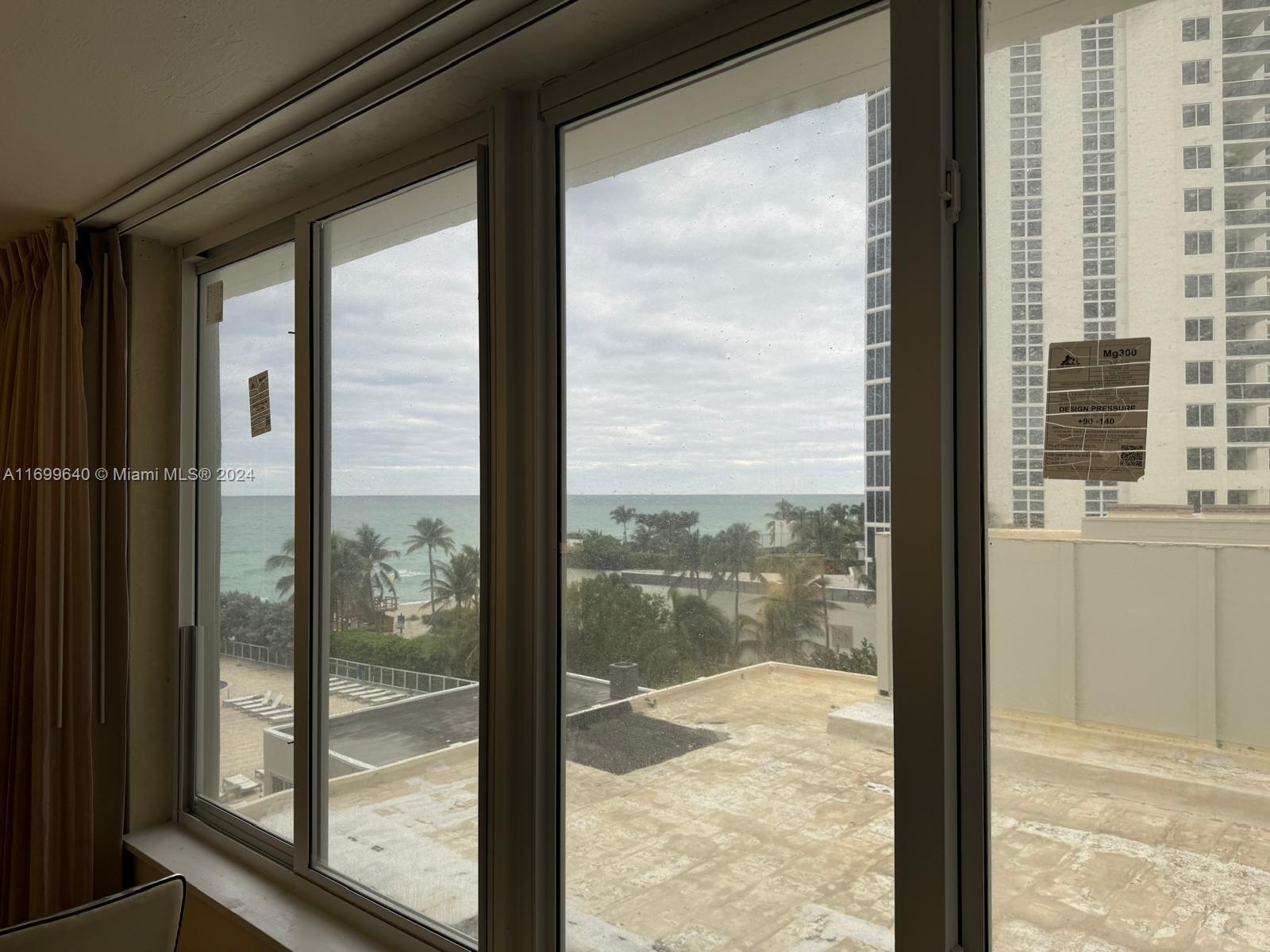 a view of a glass door and wooden floor