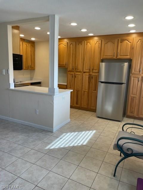 a view of kitchen with furniture and a refrigerator