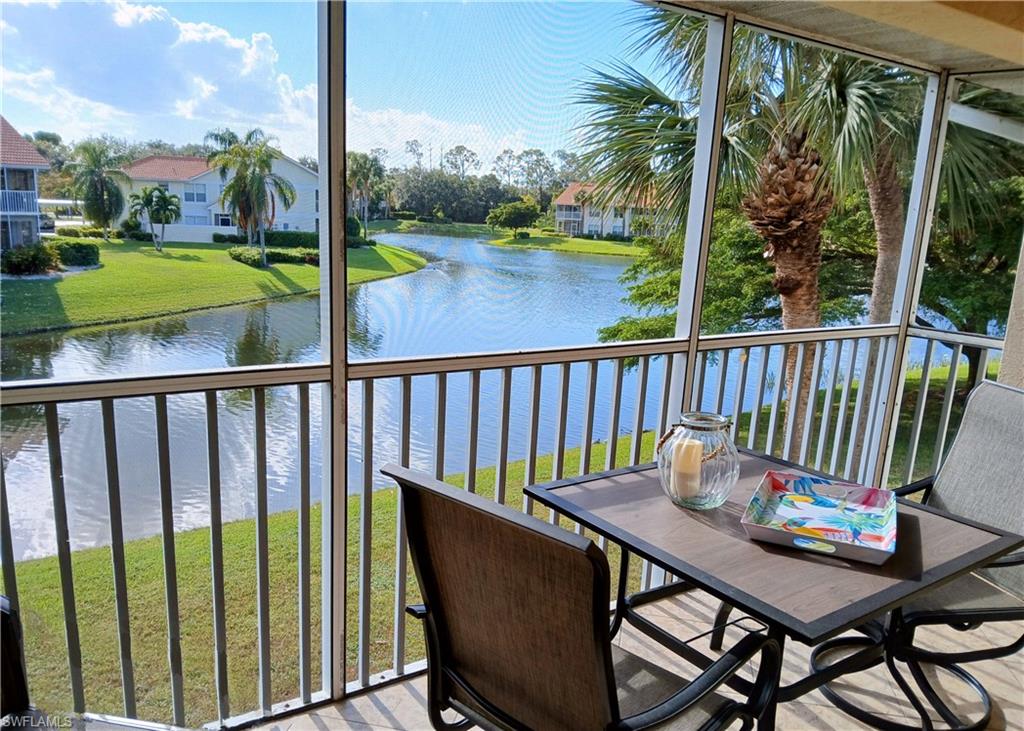 a view of a balcony with lake view and wooden floor