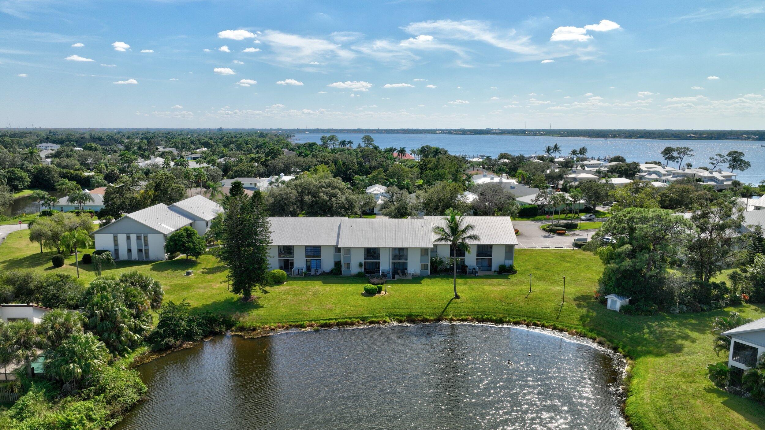 an aerial view of a house with a garden and lake view