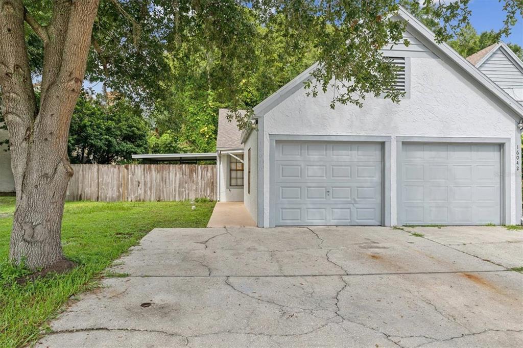 a view of backyard of house with garage