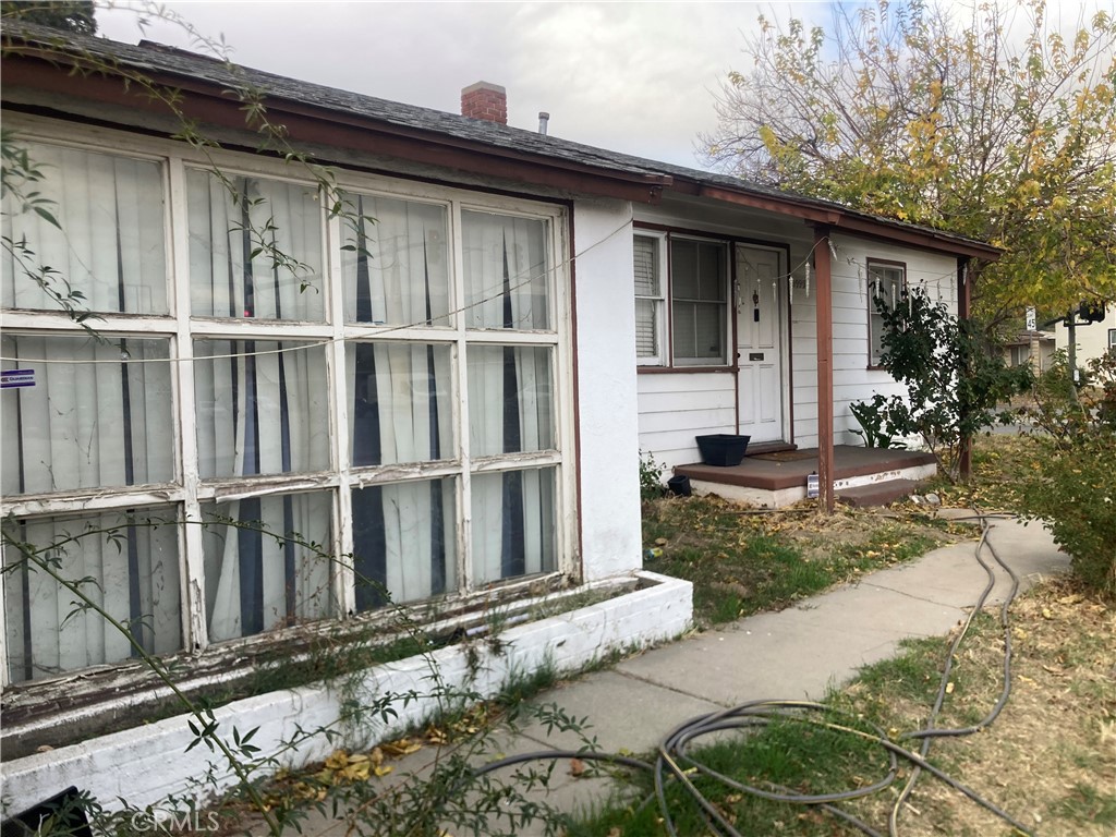 a view of a house with a wooden fence