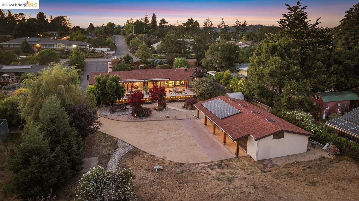 an aerial view of a house with a yard