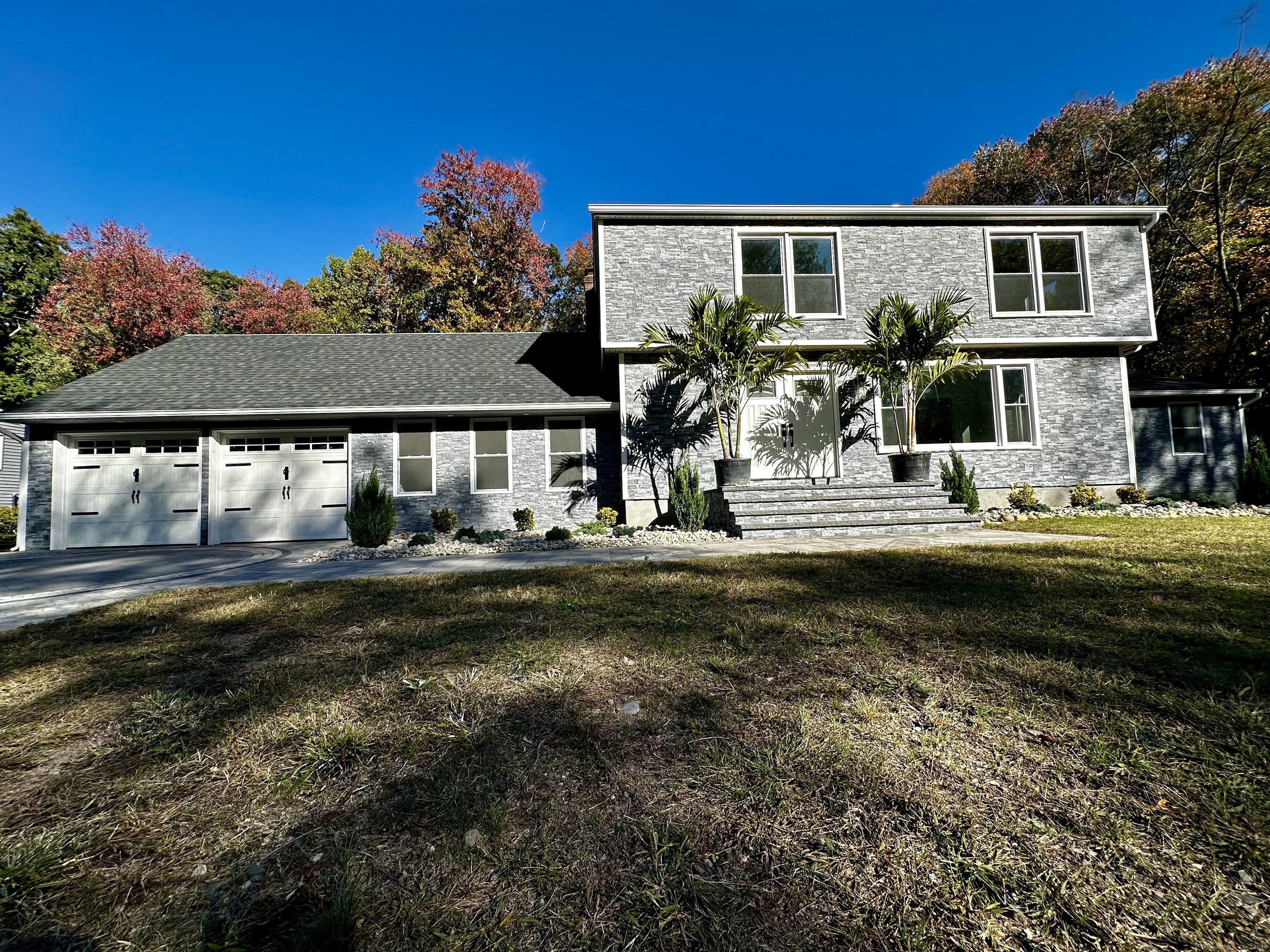 a front view of a house with garden