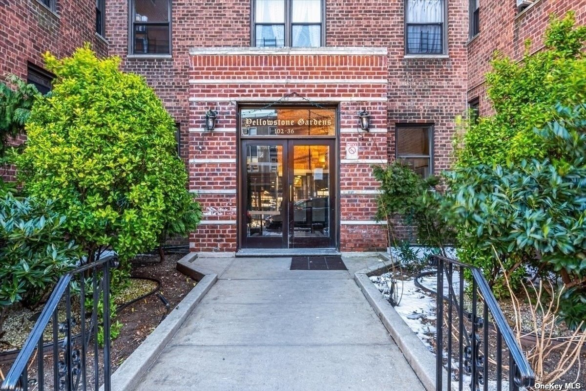 an entrance to house with yard and green space