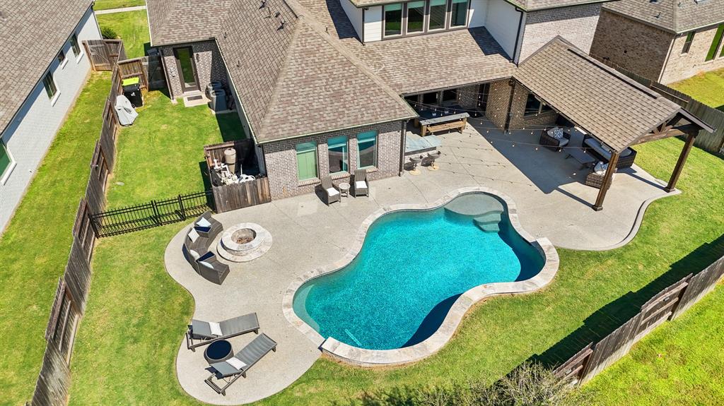 an aerial view of a house with swimming pool and glass windows