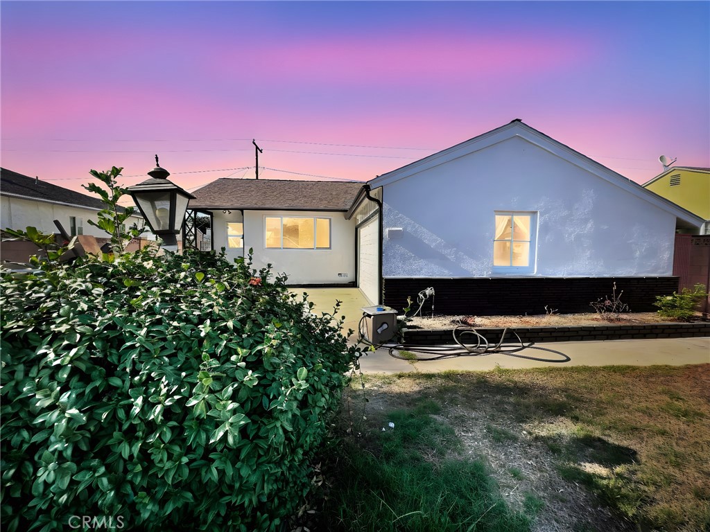 a front view of a house with yard and sitting area