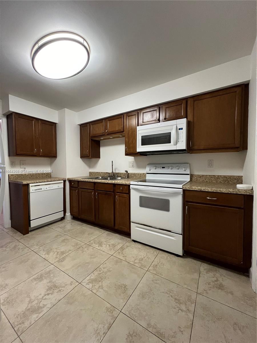 a kitchen with stainless steel appliances a stove a sink and a microwave