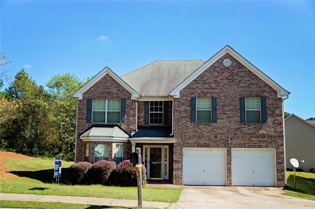 a front view of a house with a yard