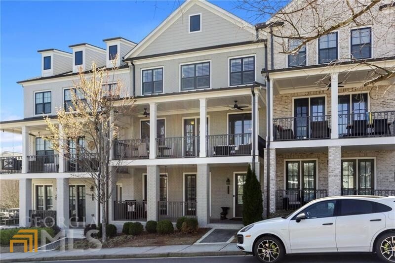 a front view of a residential apartment building with a parking space