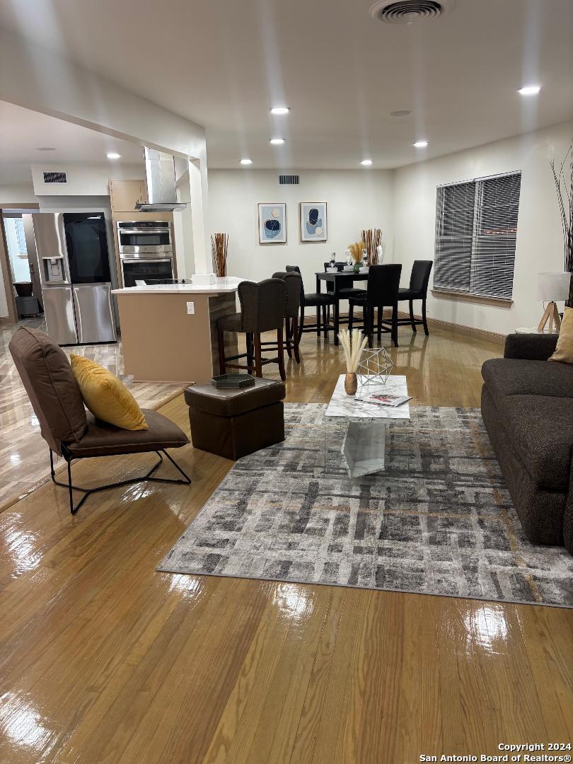 a living room with lots of furniture and kitchen view