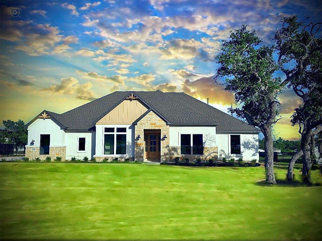 a front view of house with yard and green space