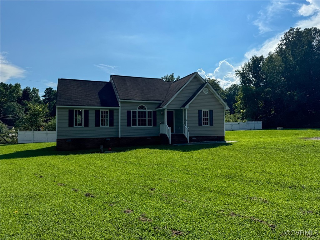 a front view of a house with yard and green space