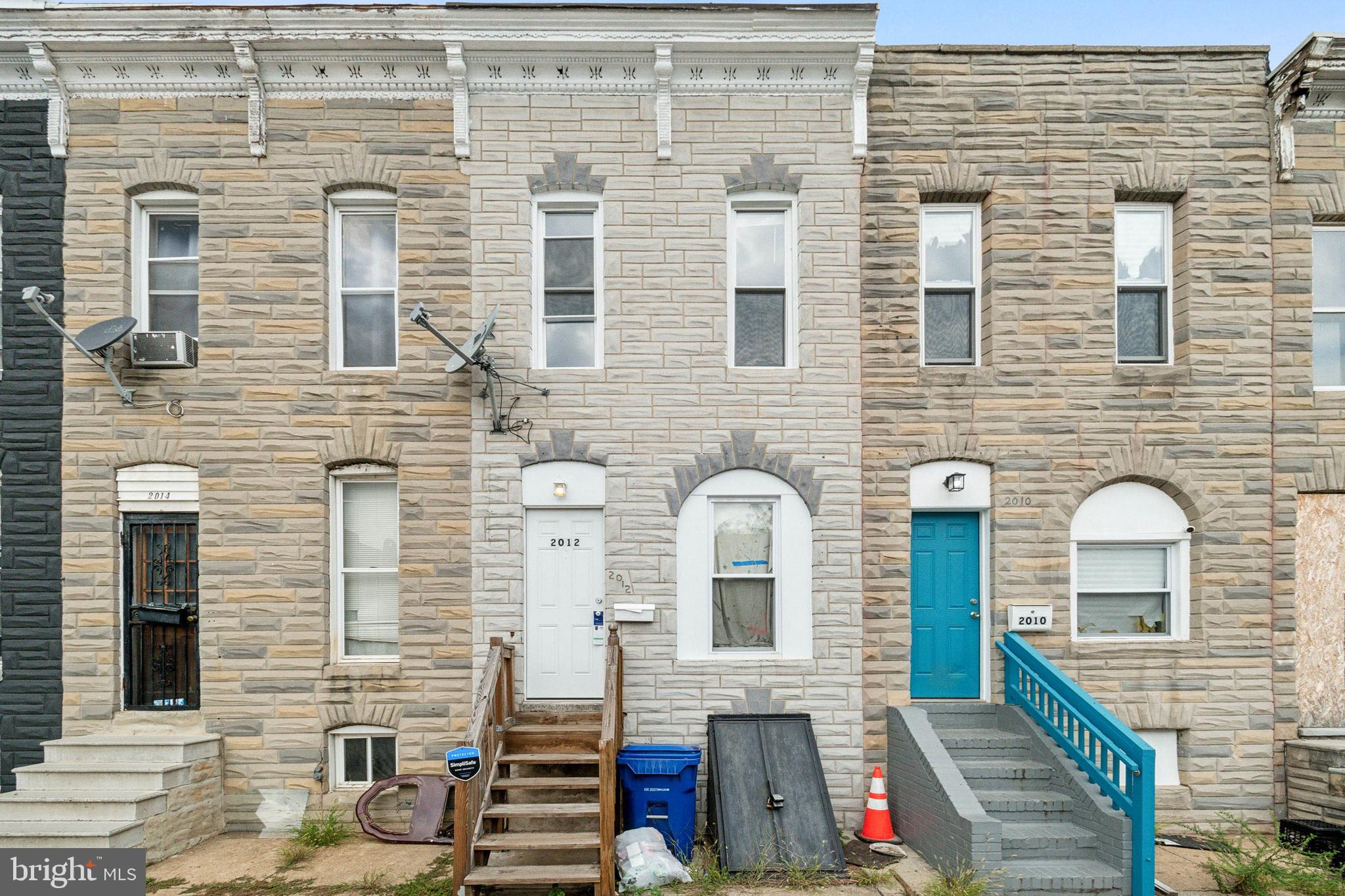 a front view of a house with wooden stairs