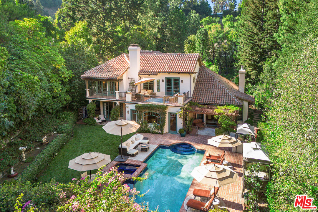 an aerial view of a house with garden space and street view