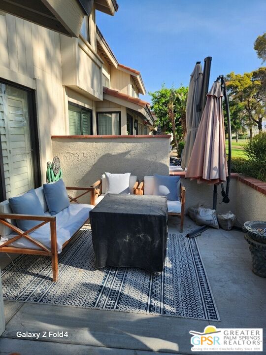 a view of a patio with table and chairs with wooden floor and a potted plant