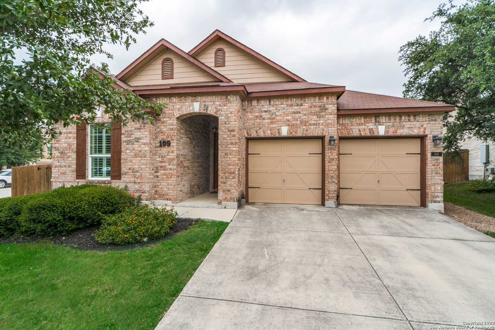 a front view of a house with a yard and garage