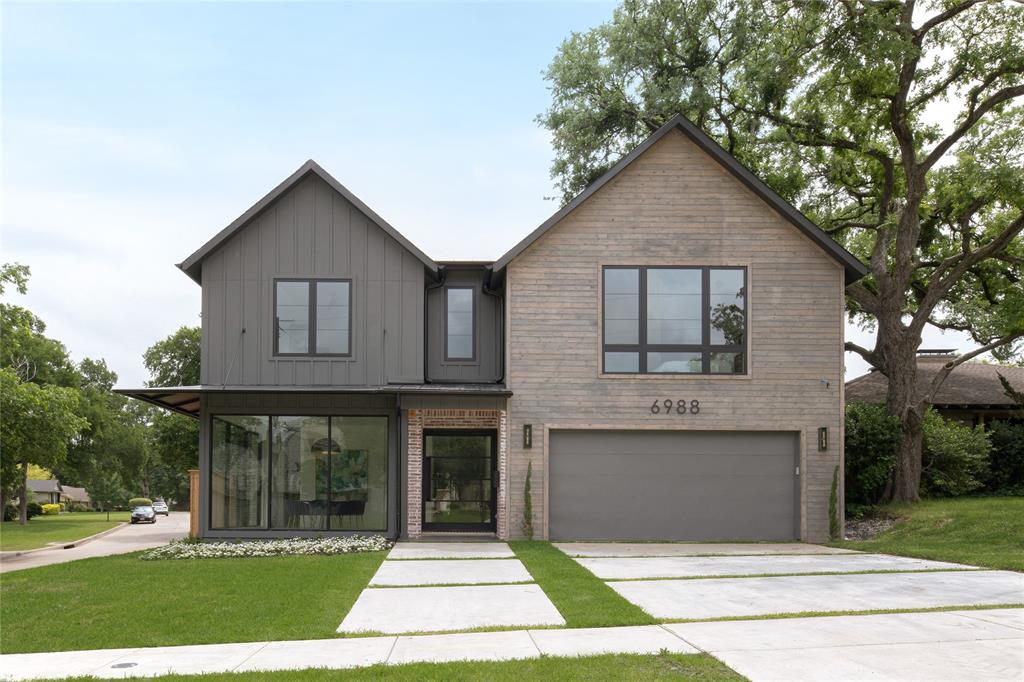 a front view of house with yard garage and trees