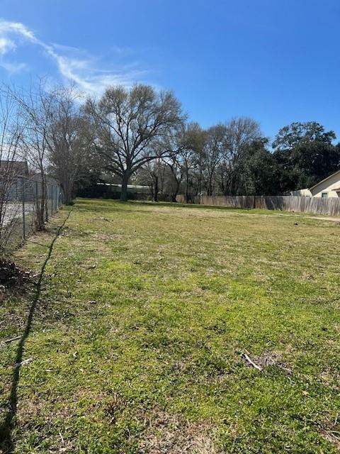 a yard with swimming pool and trees