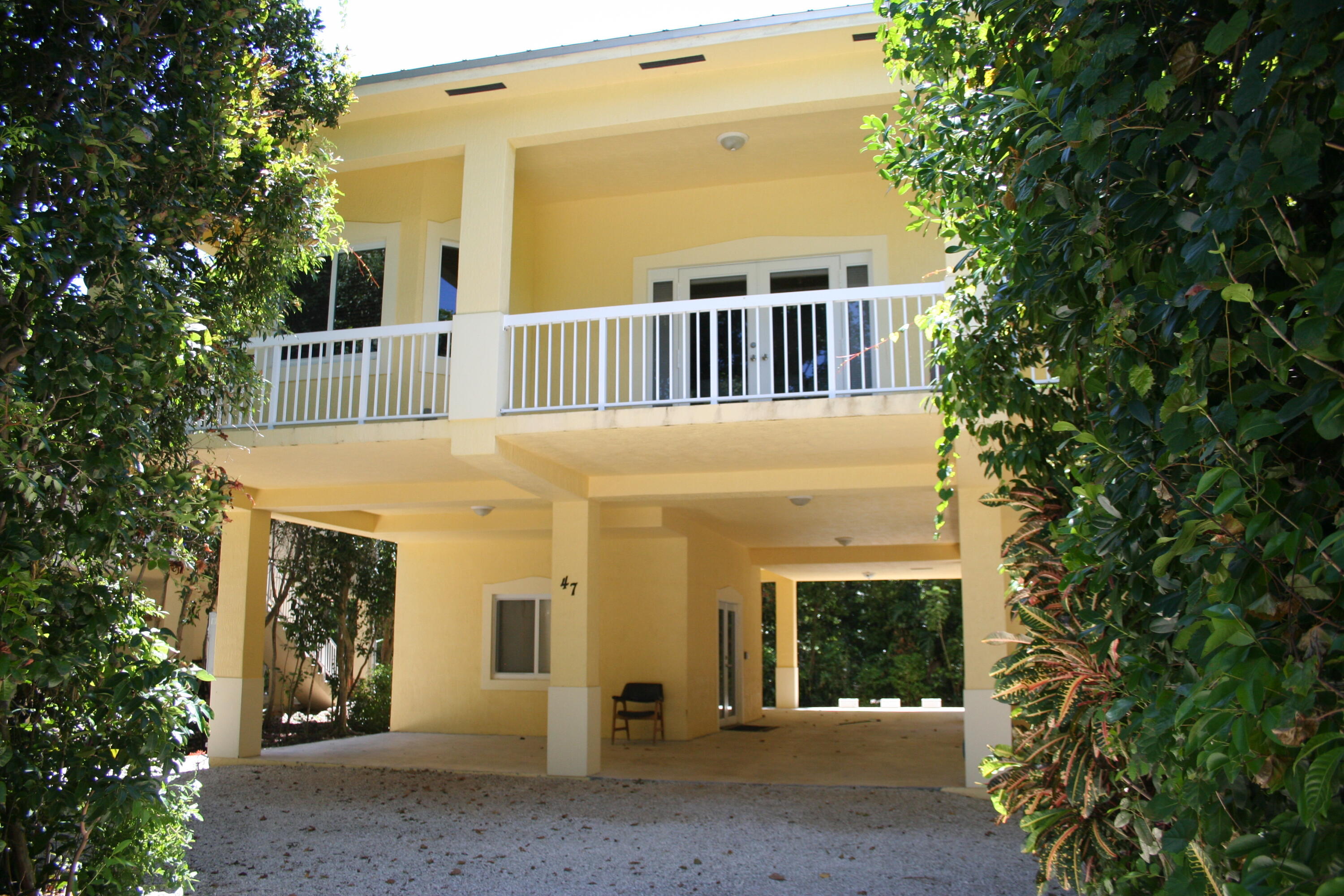 a view of a house with a tree front of house