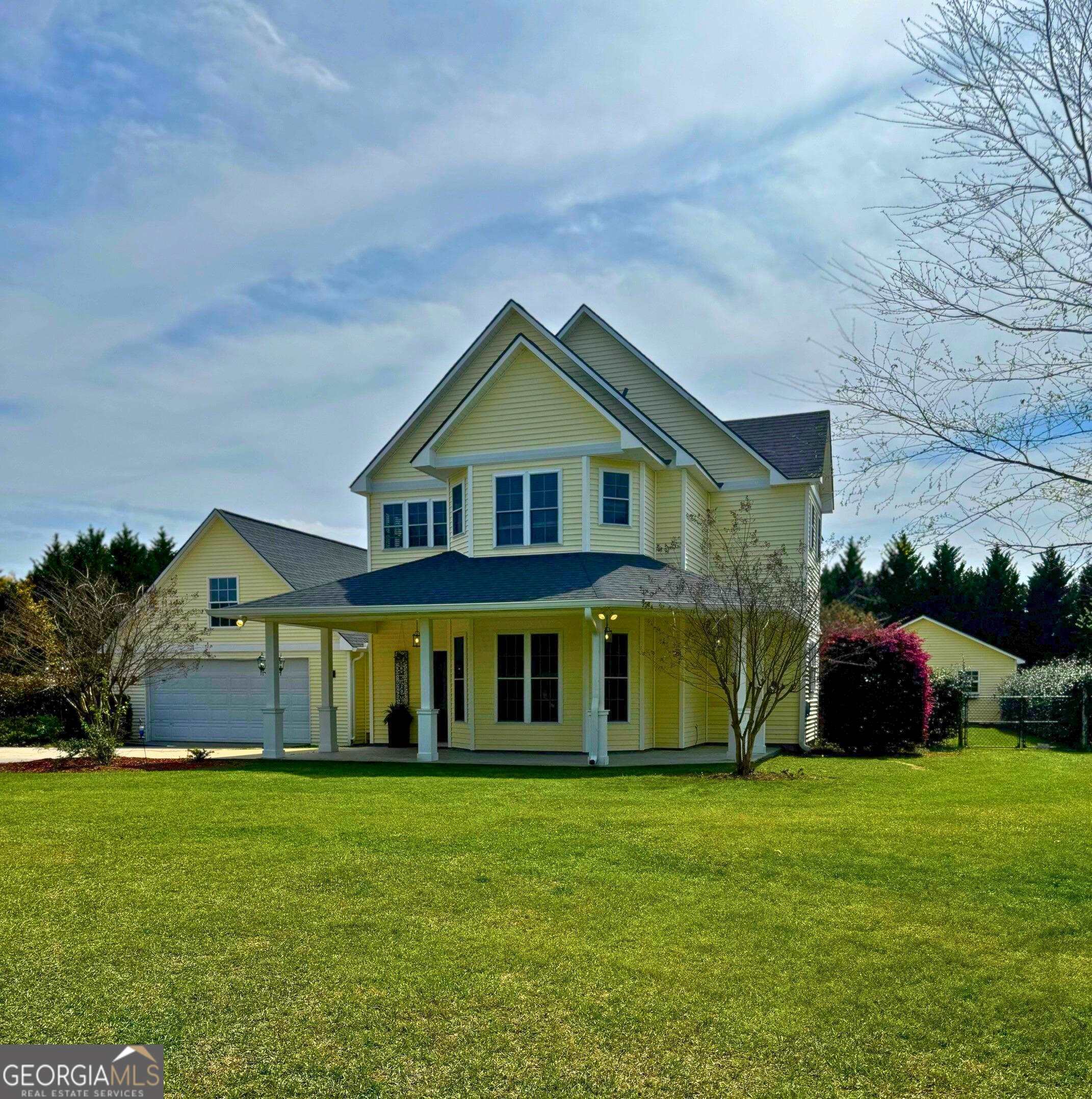 a front view of a house with a garden