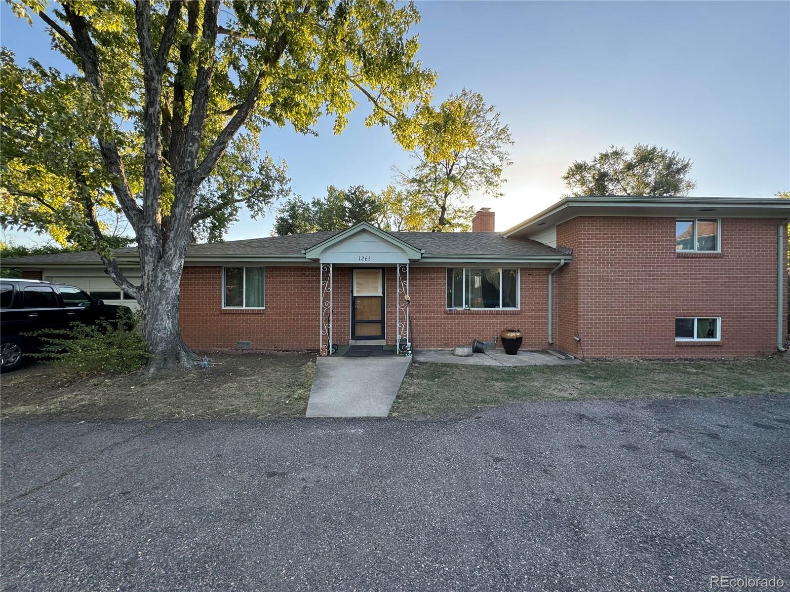 a view of a house with a tree in the background