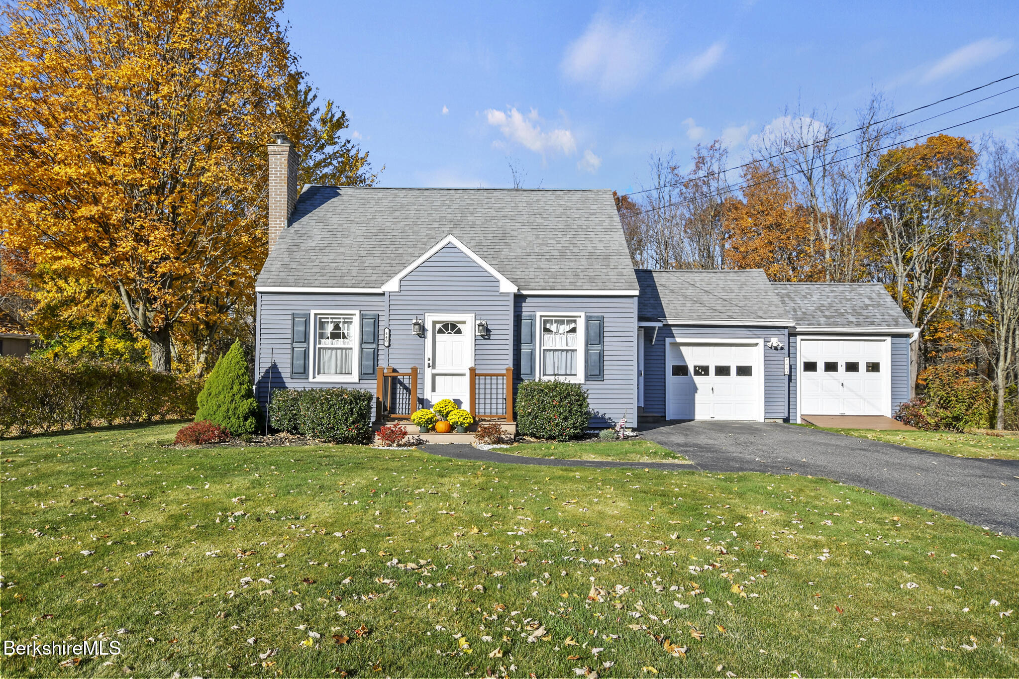 a front view of house with yard and green space